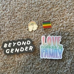 Two pride pins and two stickers